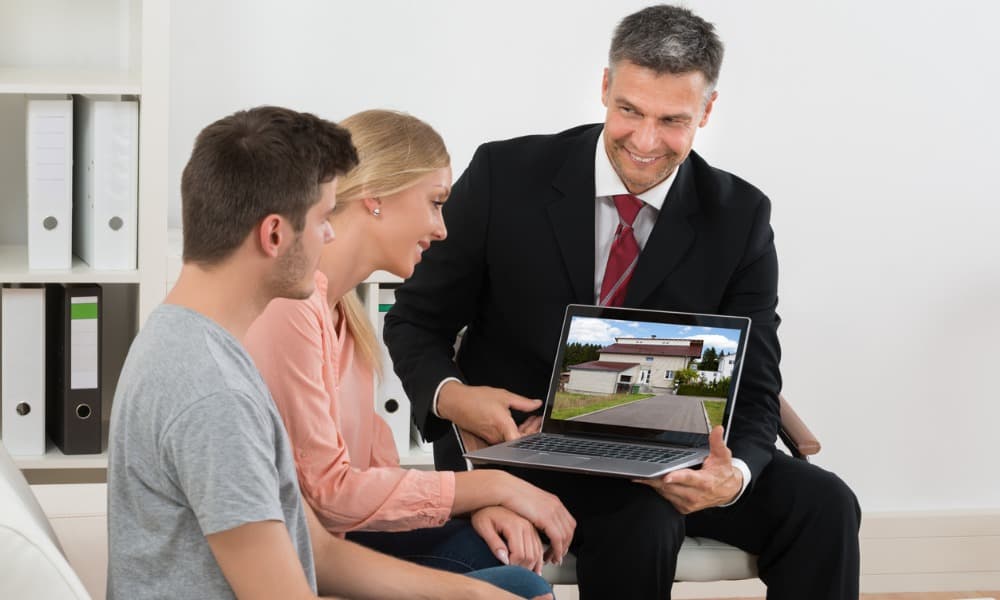 enhance-local-reach-with-real-estate-video A couple taking a video tour of a property for sale.