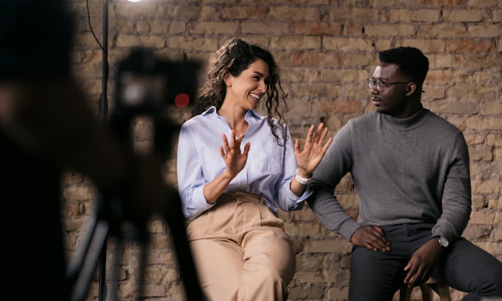 Two agents shooting a video in a studio to increase real estate sales
