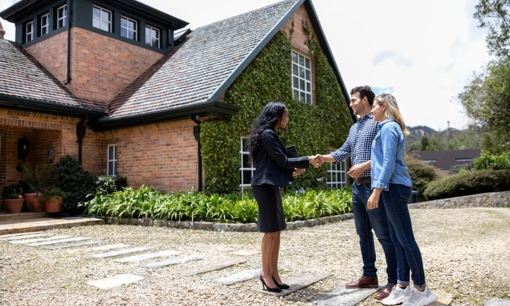 Real estate agent showing a house to clients