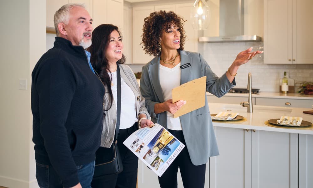 Real estate agent who’s used personal branding, showing a property to a couple